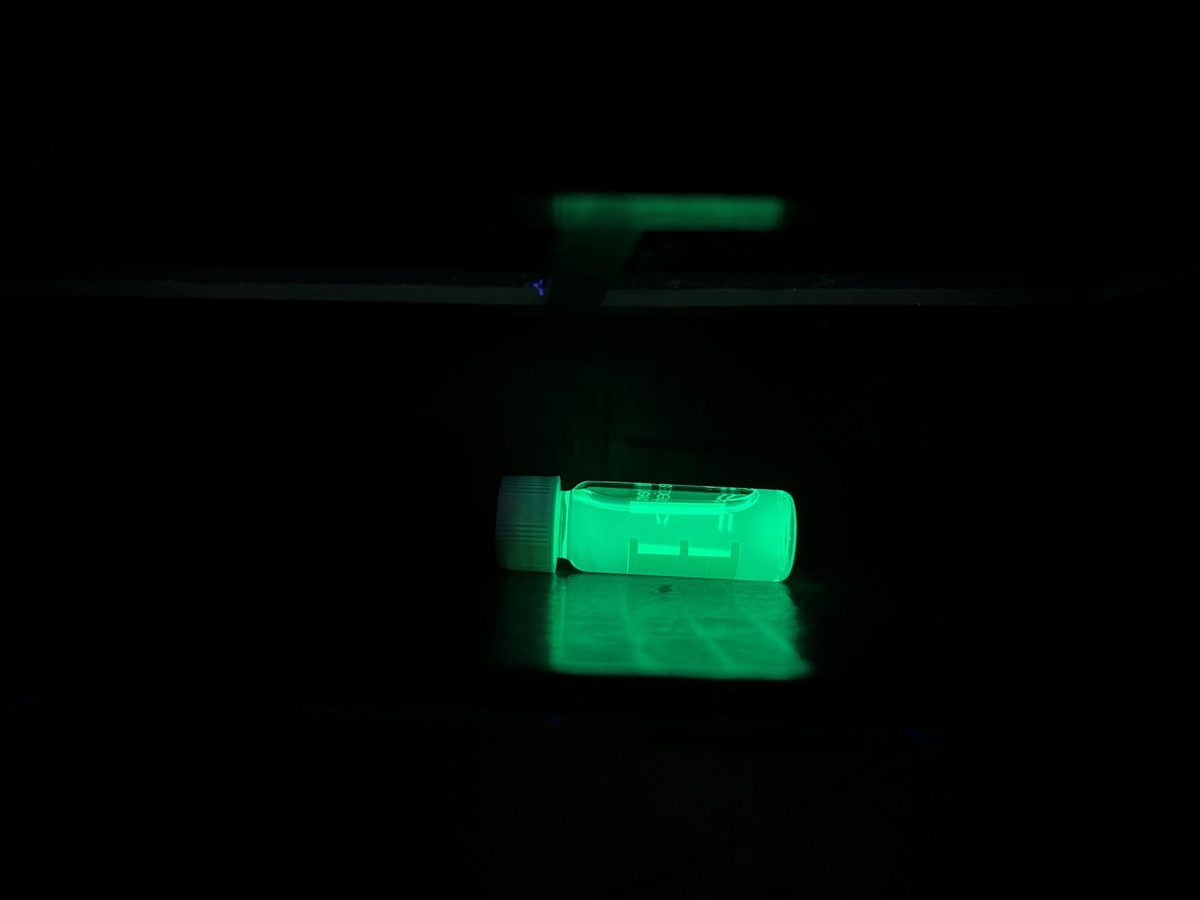 A thin film emitting bright green light in a darkened room